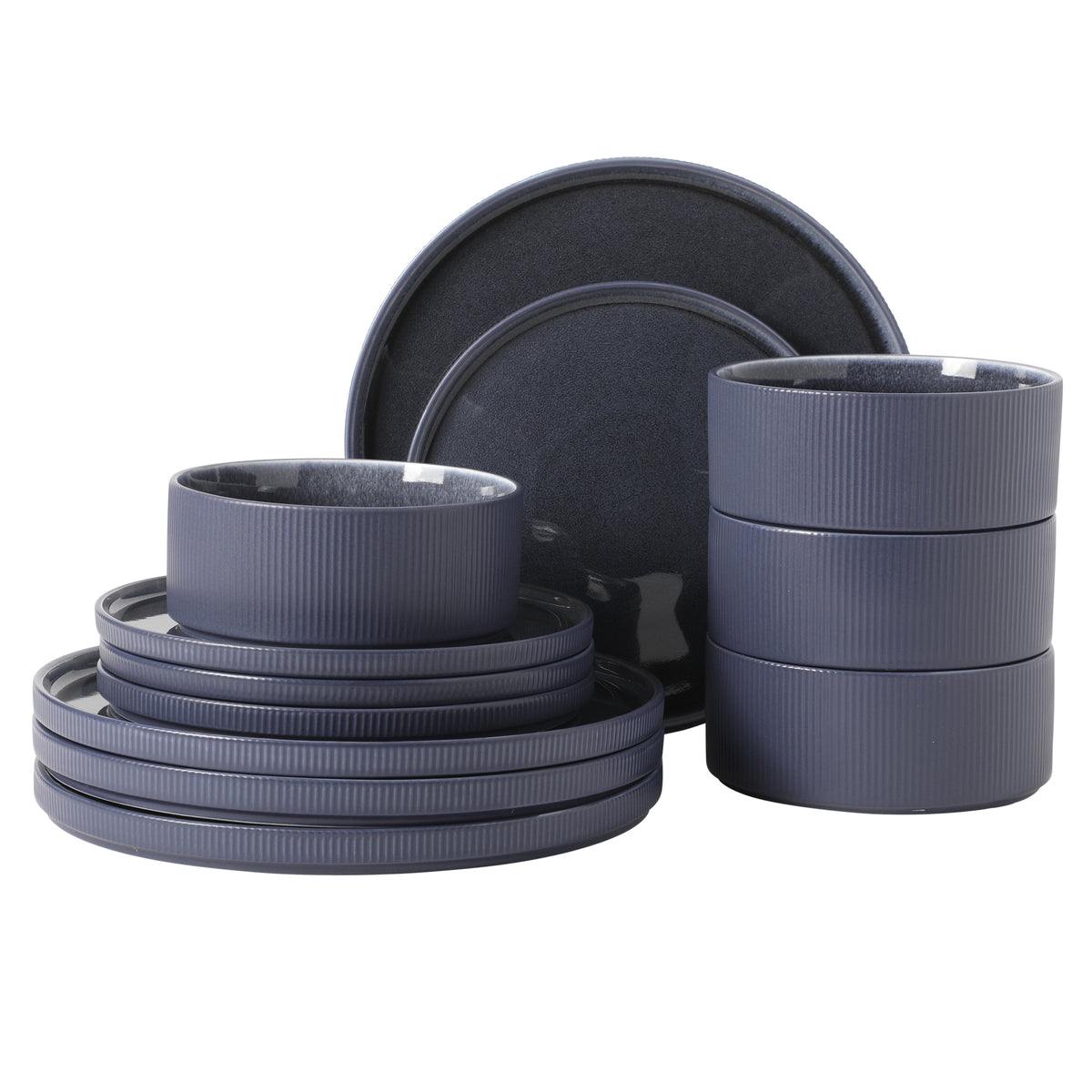 Gibson Elite Redrock Canyon 12-piece new bone china dinnerware set in a slate blue-grey reactive glaze with a ribbed, vertically fluted texture, including cylindrical bowls and plates.